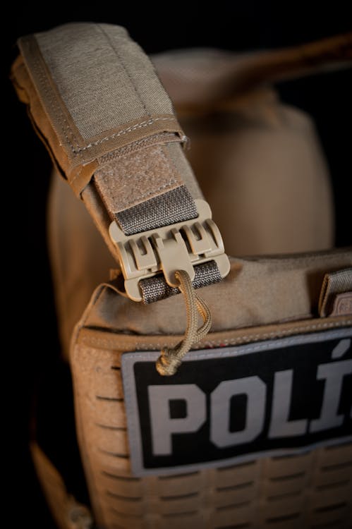 Free Detailed shot of a tactical police vest strap with a strong buckle. Stock Photo