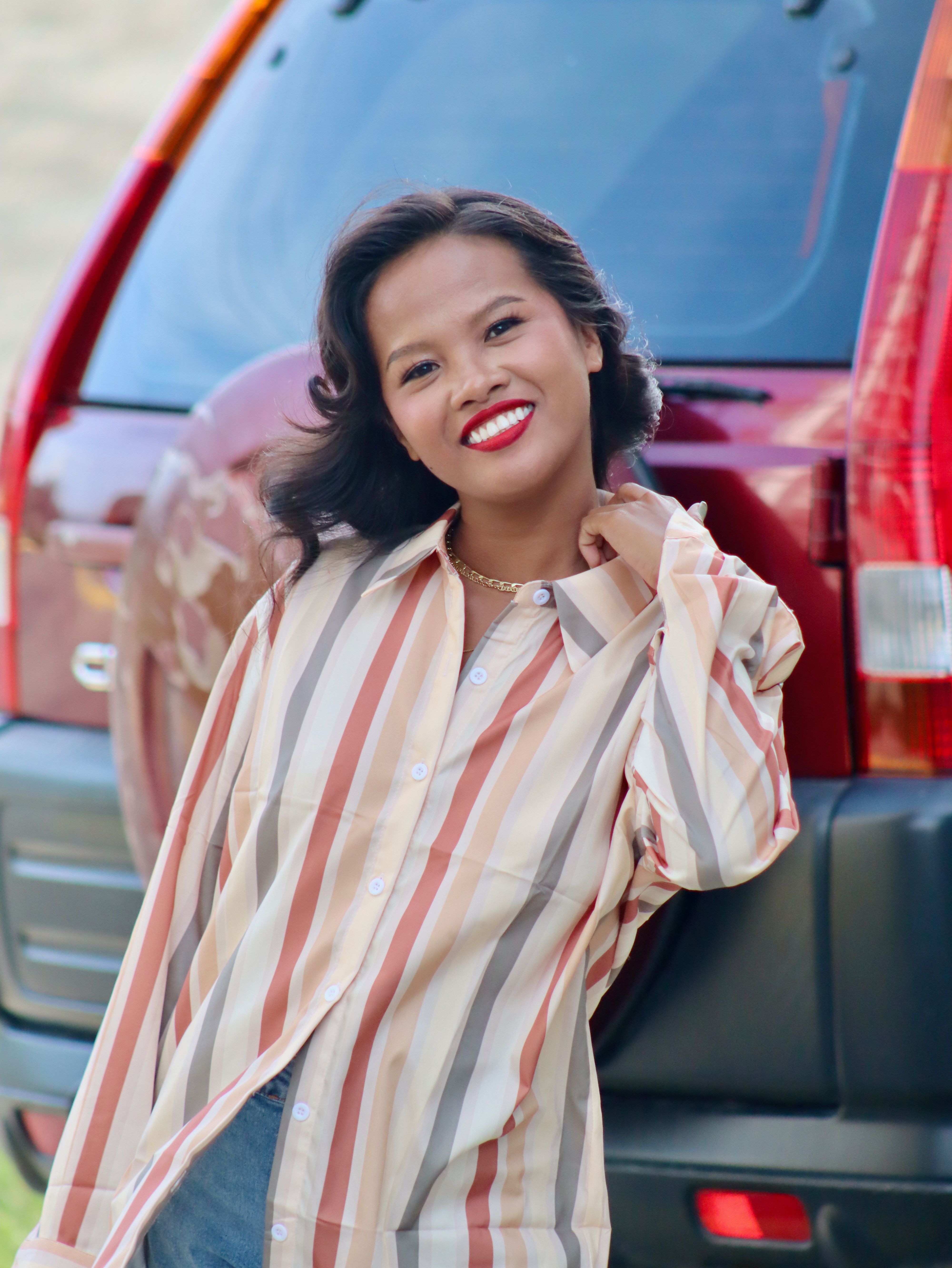 Smiling Woman in Striped Shirt Outdoors · Free Stock Photo