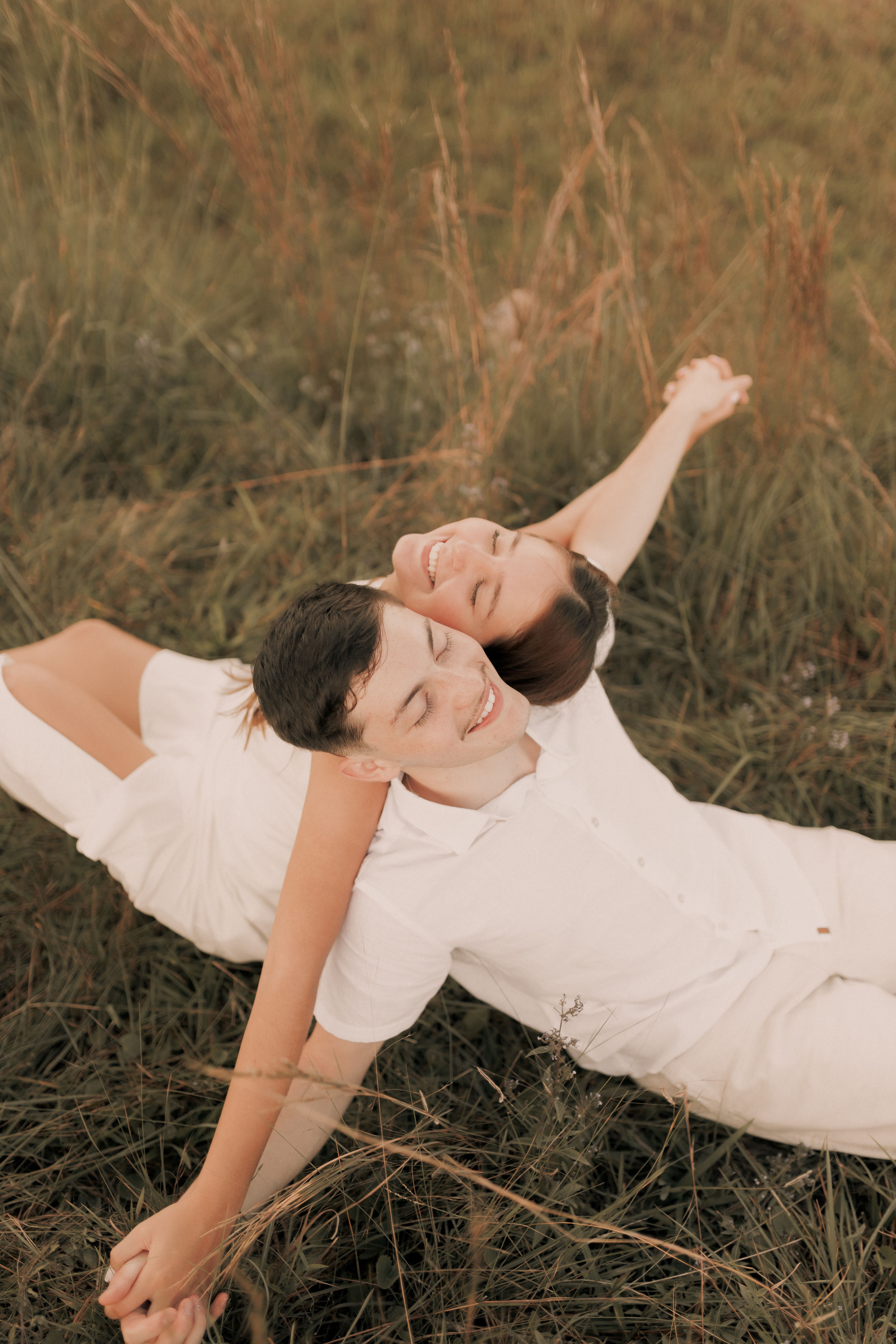 Man and Woman Lying on Green Grass Field · Free Stock Photo