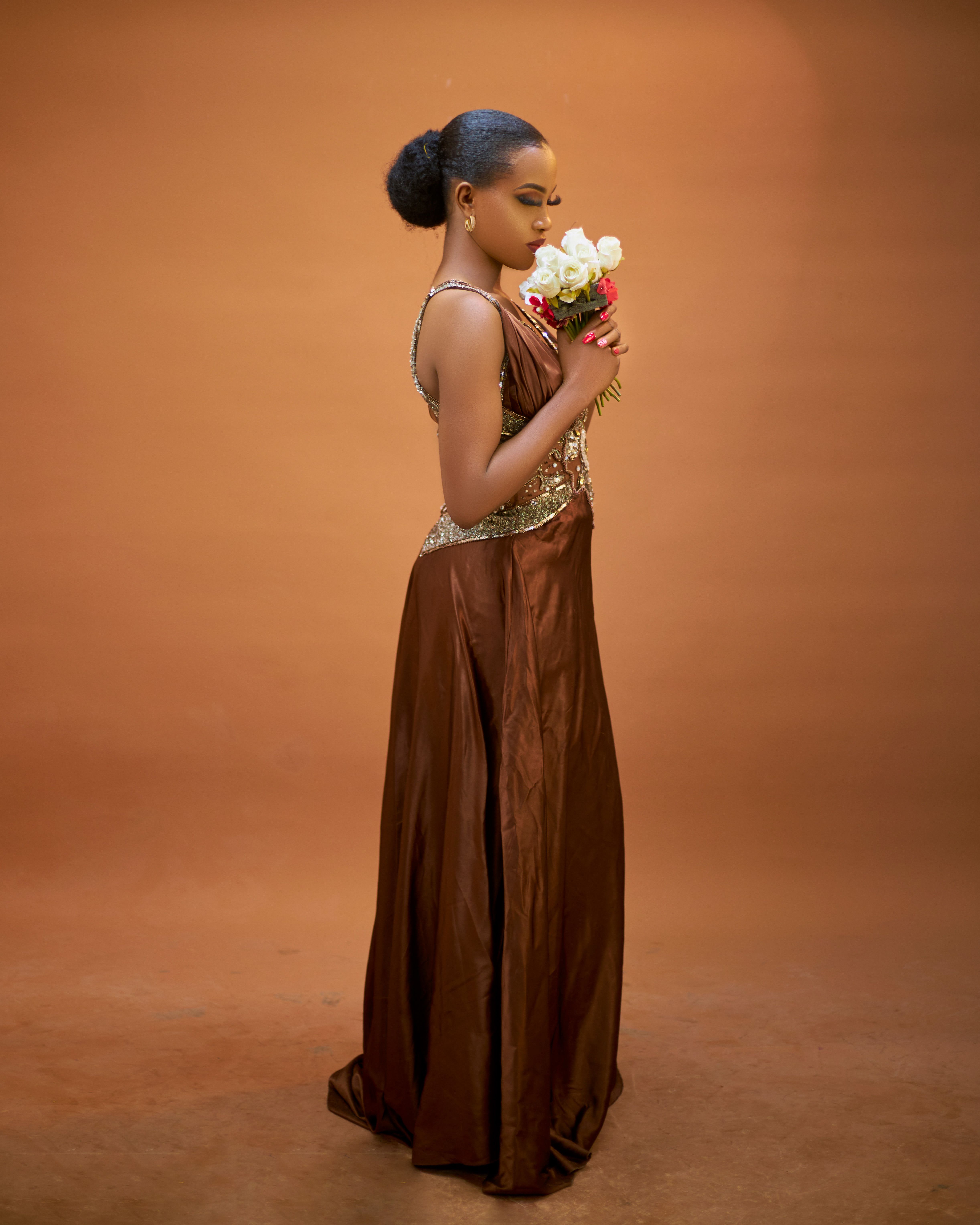 Elegant Woman in Brown Dress with Flowers · Free Stock Photo — free download
