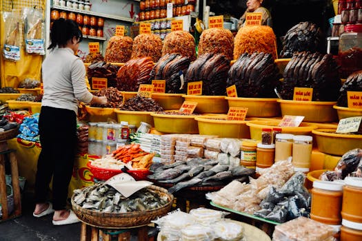 A bustling Vietnamese market stall with diverse dried goods and spices on display.