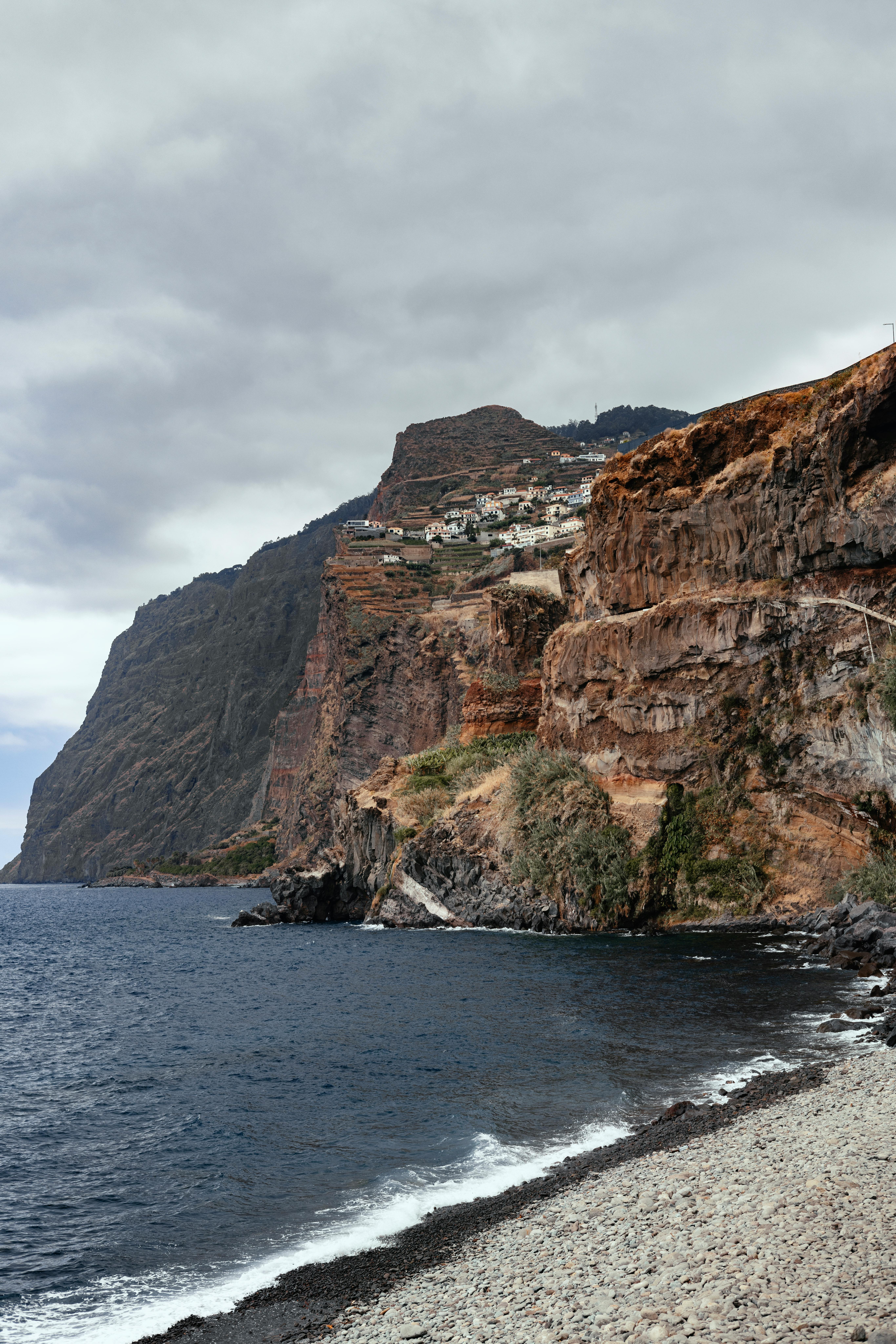 Majestic cliffs along the ocean in Madeira, Portugal, displaying natural beauty and rugged terrain.