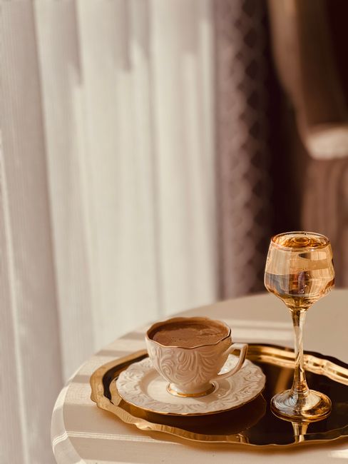 Stylish coffee and water set on a sunlit table in Ankara, creating a warm and inviting ambiance.