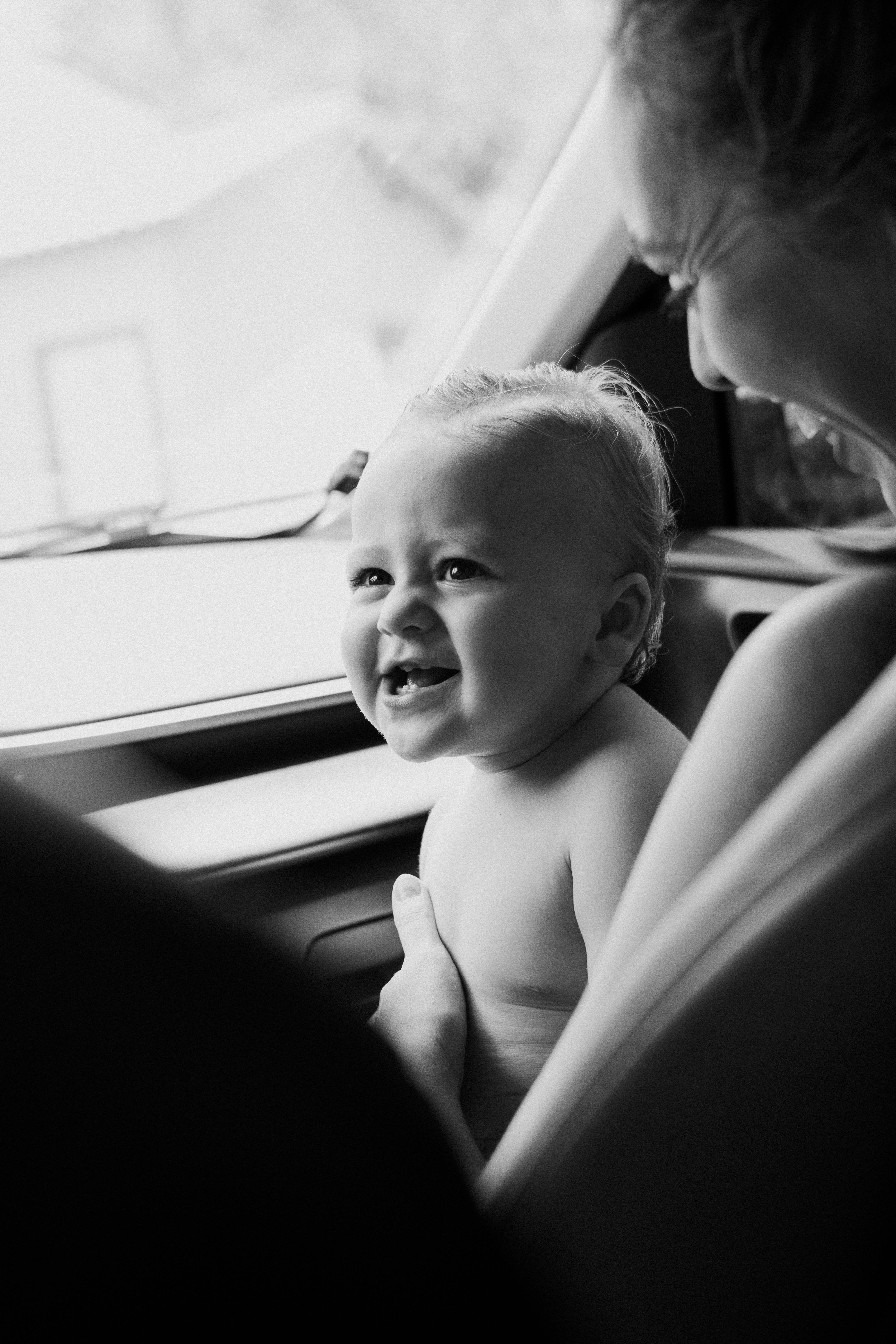 joyful baby smiling in black and white photo