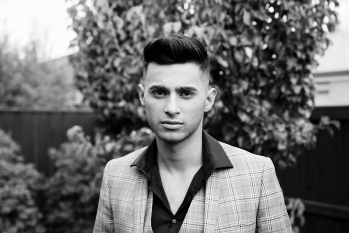 Black and white portrait of a young man in a checked jacket