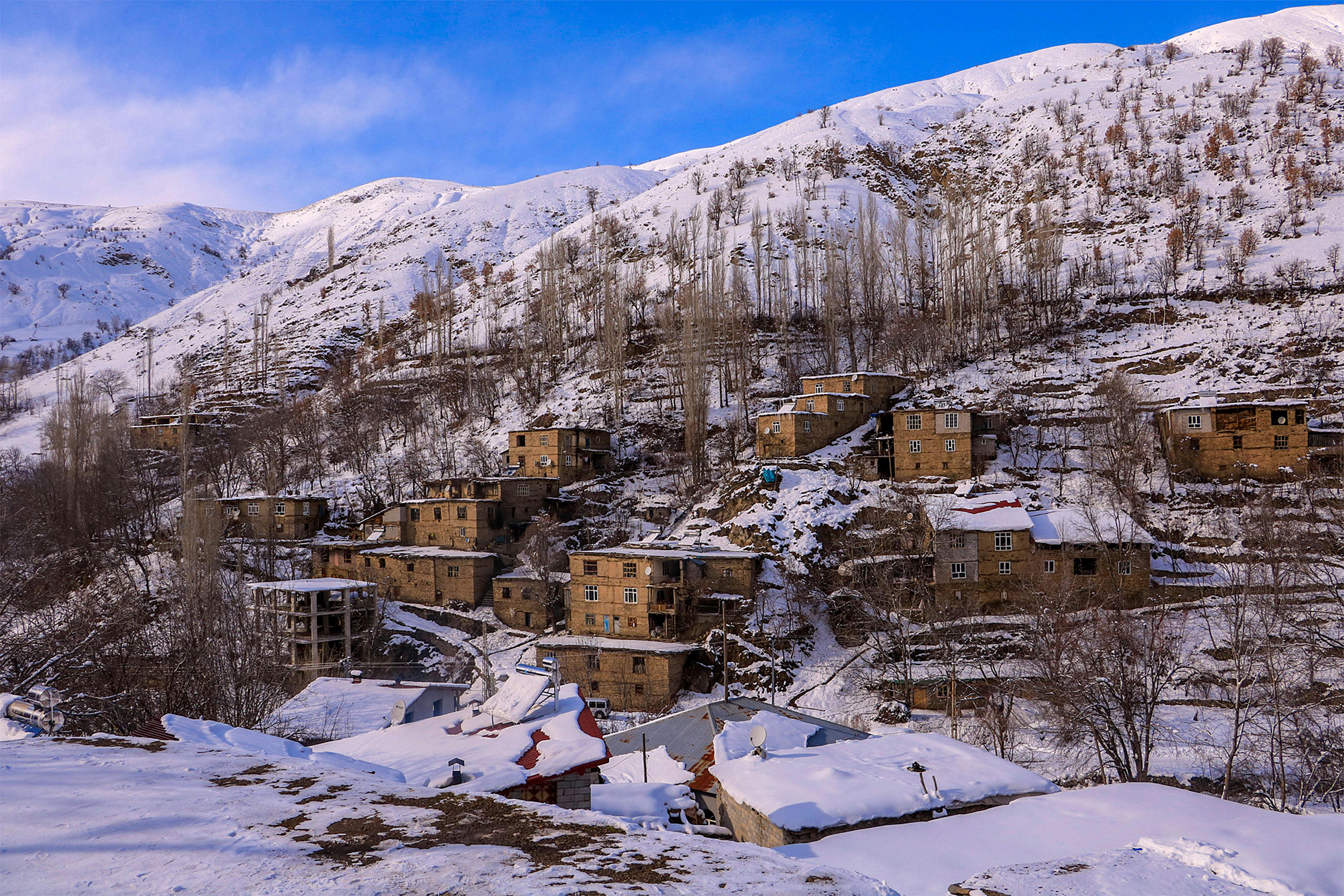 Snow-covered village in Hizan, Bitlis, Türkiye captured during winter, showcasing rustic architecture.