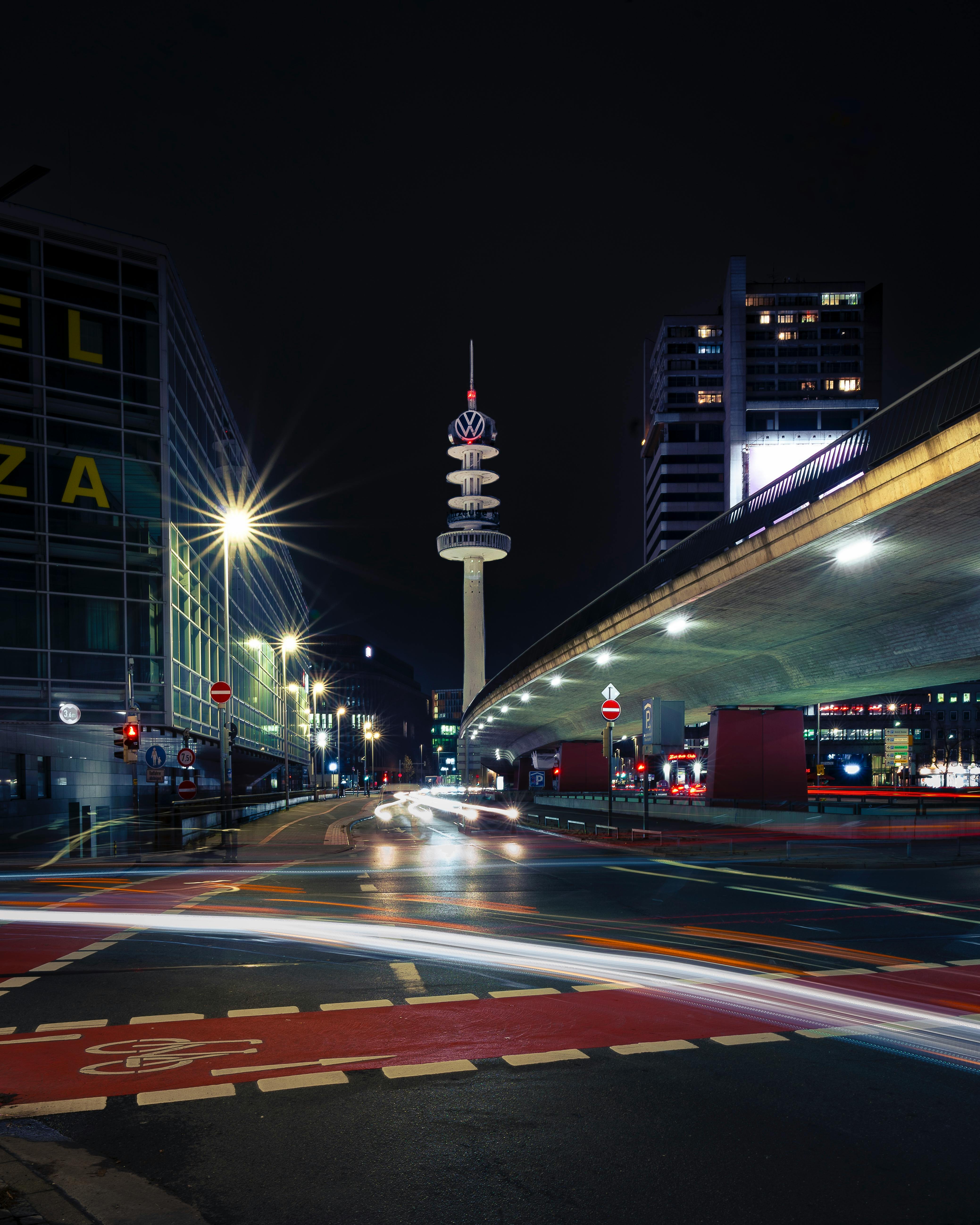 Dramatic night scene in Hannover showcasing Niederpost's Telekom Tower and vibrant city lights.