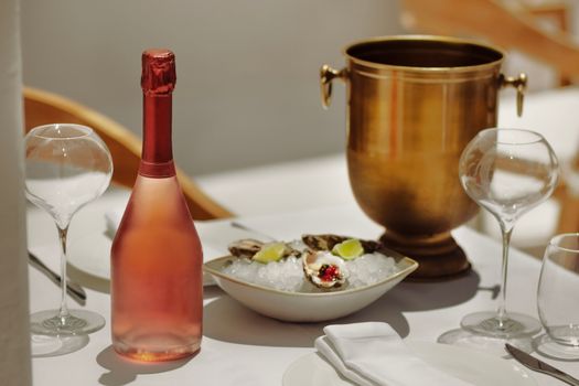 Sophisticated dining with rosé wine, oysters, and luxurious setting. Perfect for a cozy celebration.