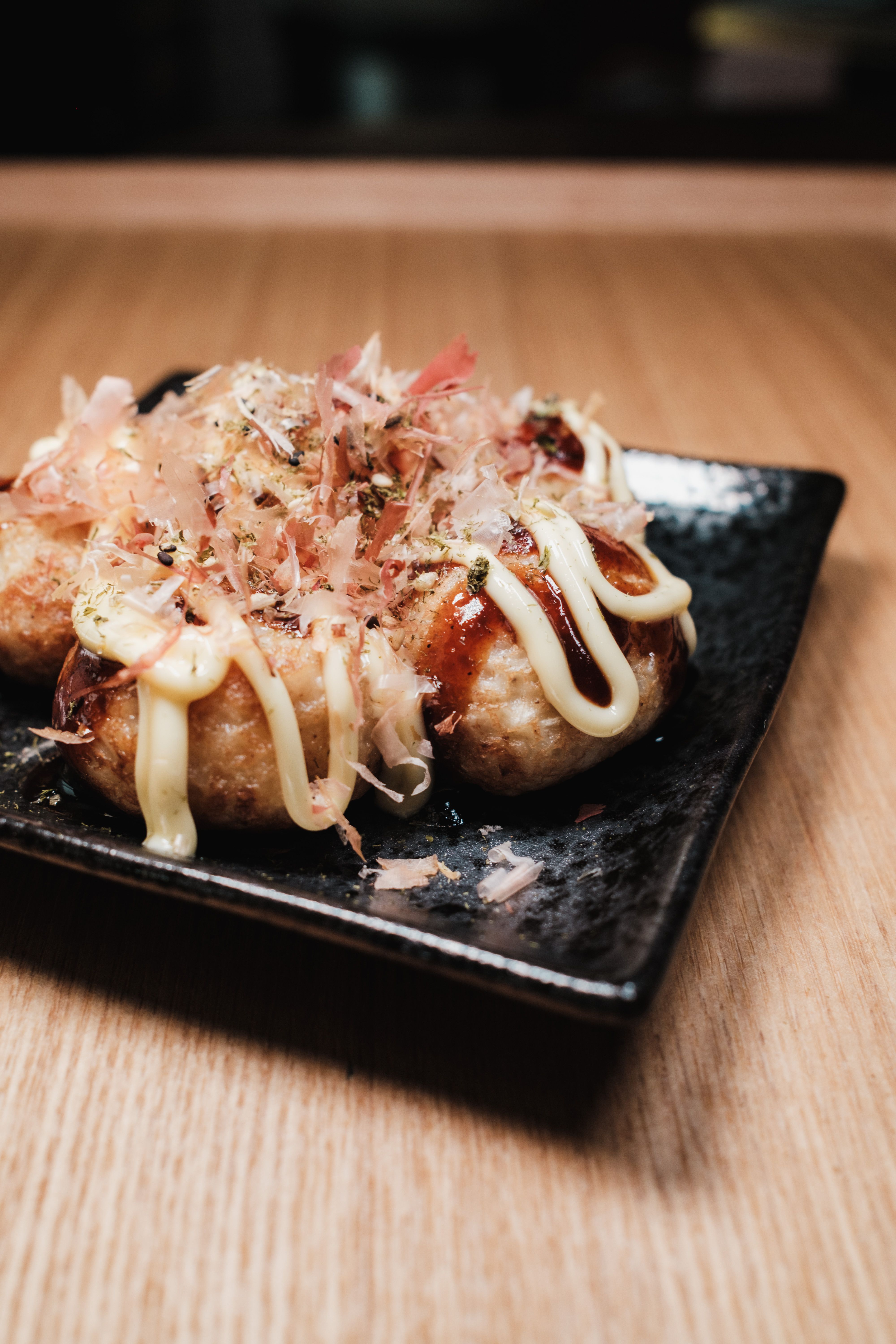 Japanese rice balls topped with furikake seasoning on black plate