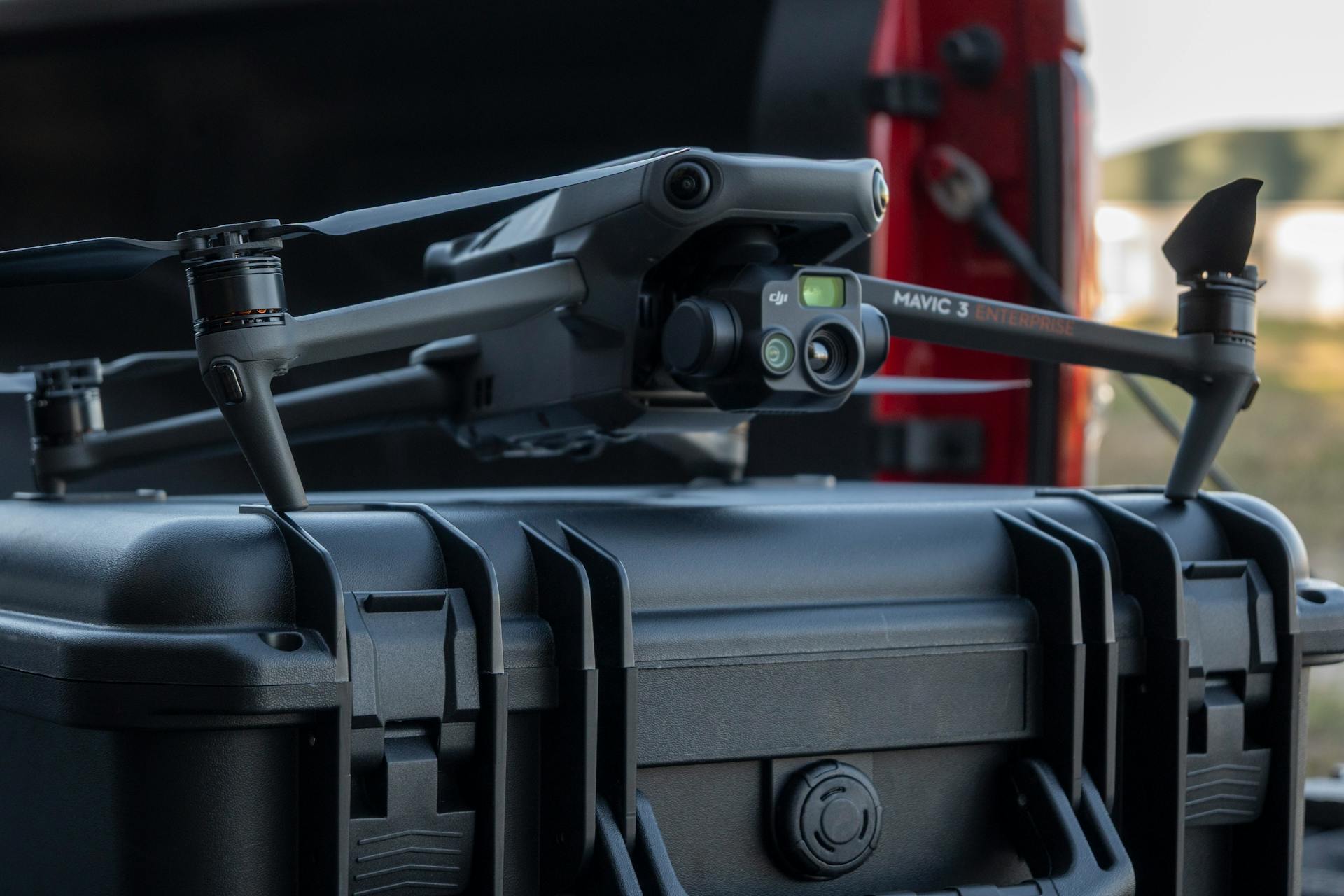 A DJI Mavic 3 Enterprise drone sits on a rugged equipment case, ready for deployment.