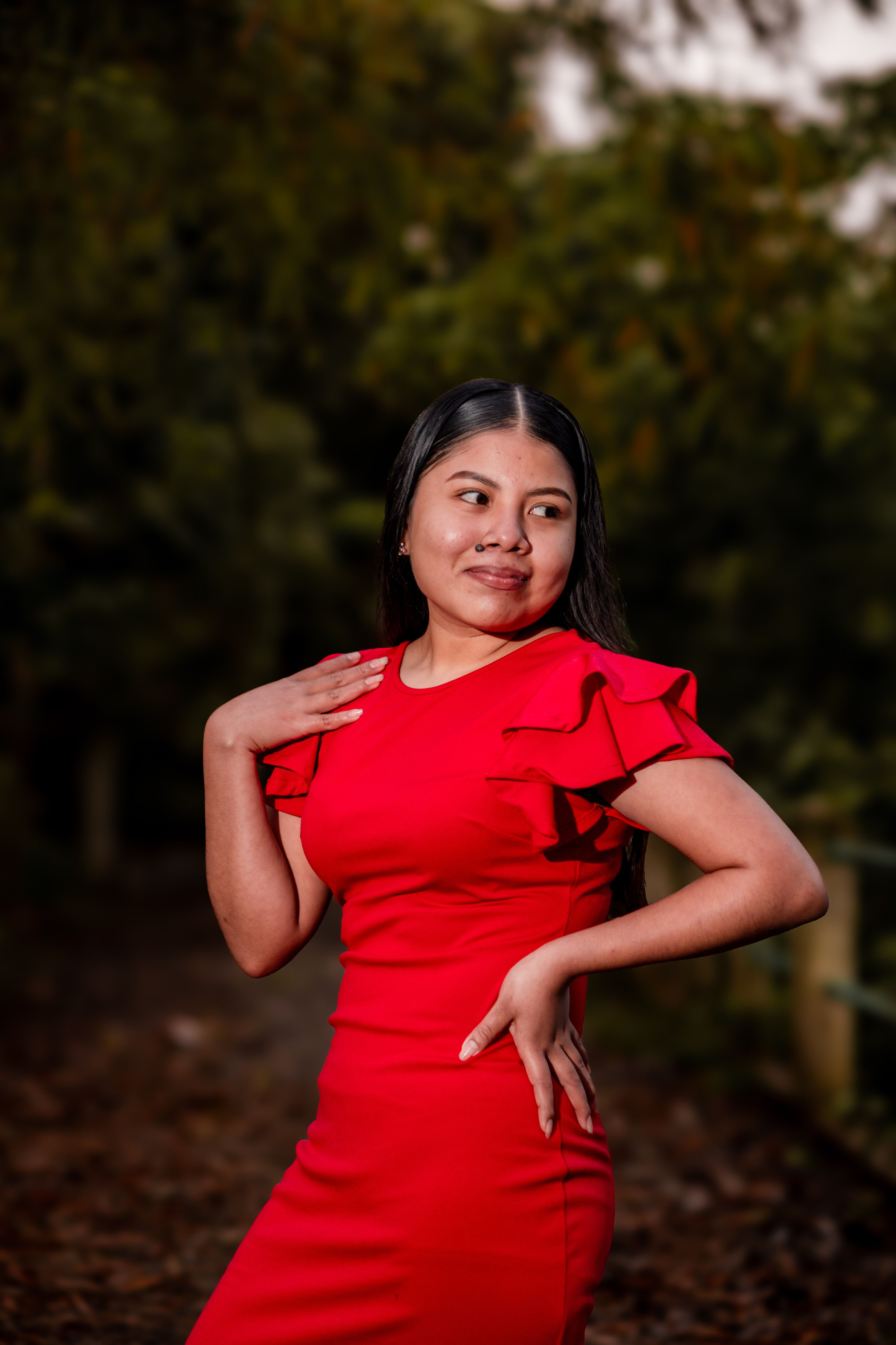 Confident Woman in Red Dress Outdoors · Free Stock Photo