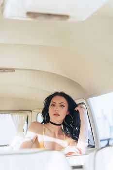 Elegant fashion model posing inside a vintage car during a daylight photoshoot in Melbourne, Australia.
