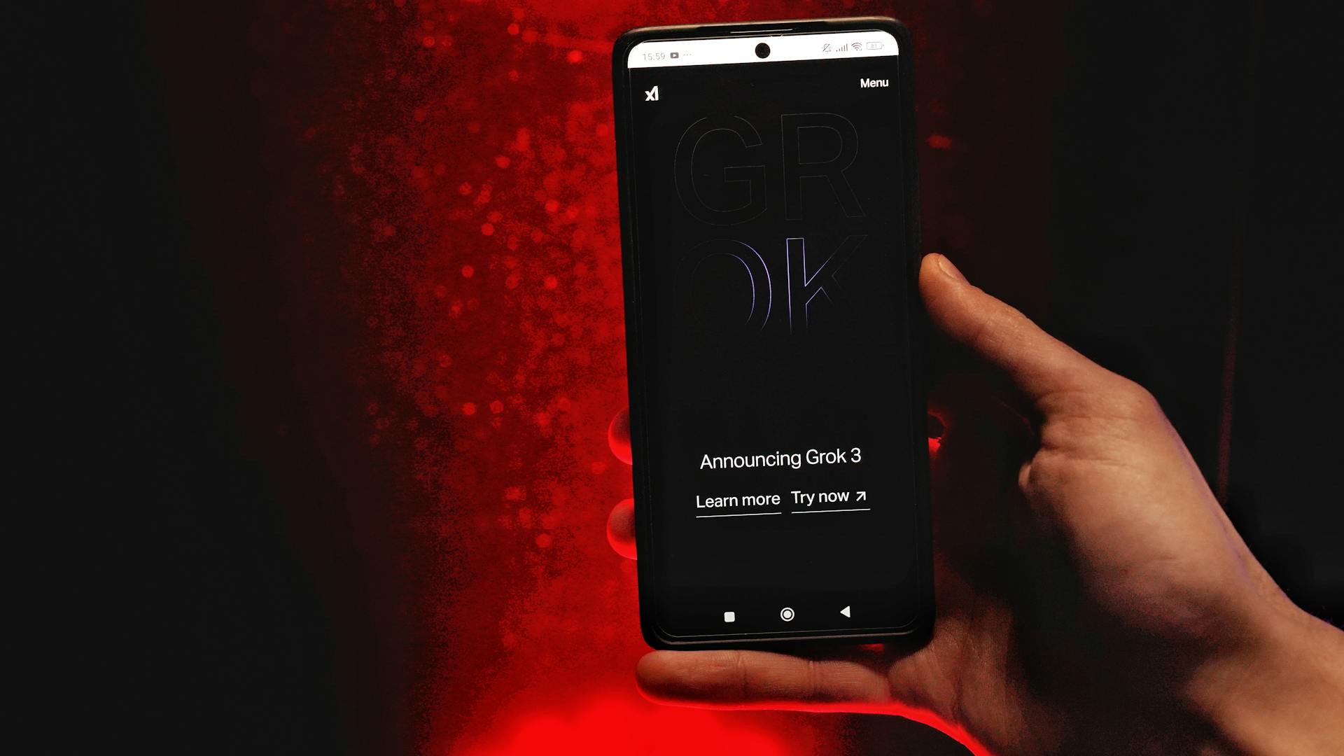 A hand holds a smartphone displaying Grok 3 announcement against a red background.