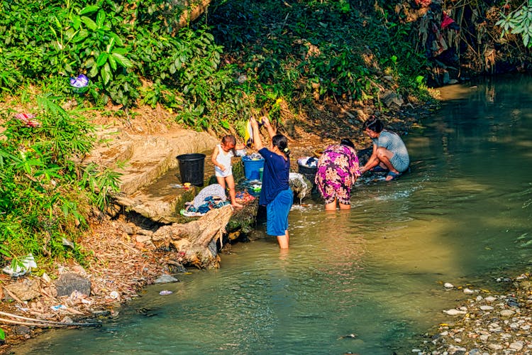 Women Washing Clothes By The River