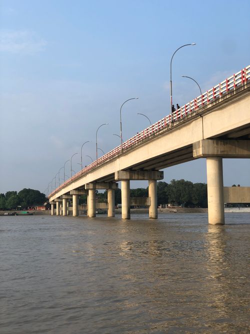 Free Scenic view of a concrete bridge spanning the Padma River in Kushtia, Bangladesh, with calm waters below. Stock Photo