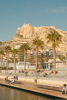 View of Santa Bárbara Castle with palm trees in Alicante, Spain.