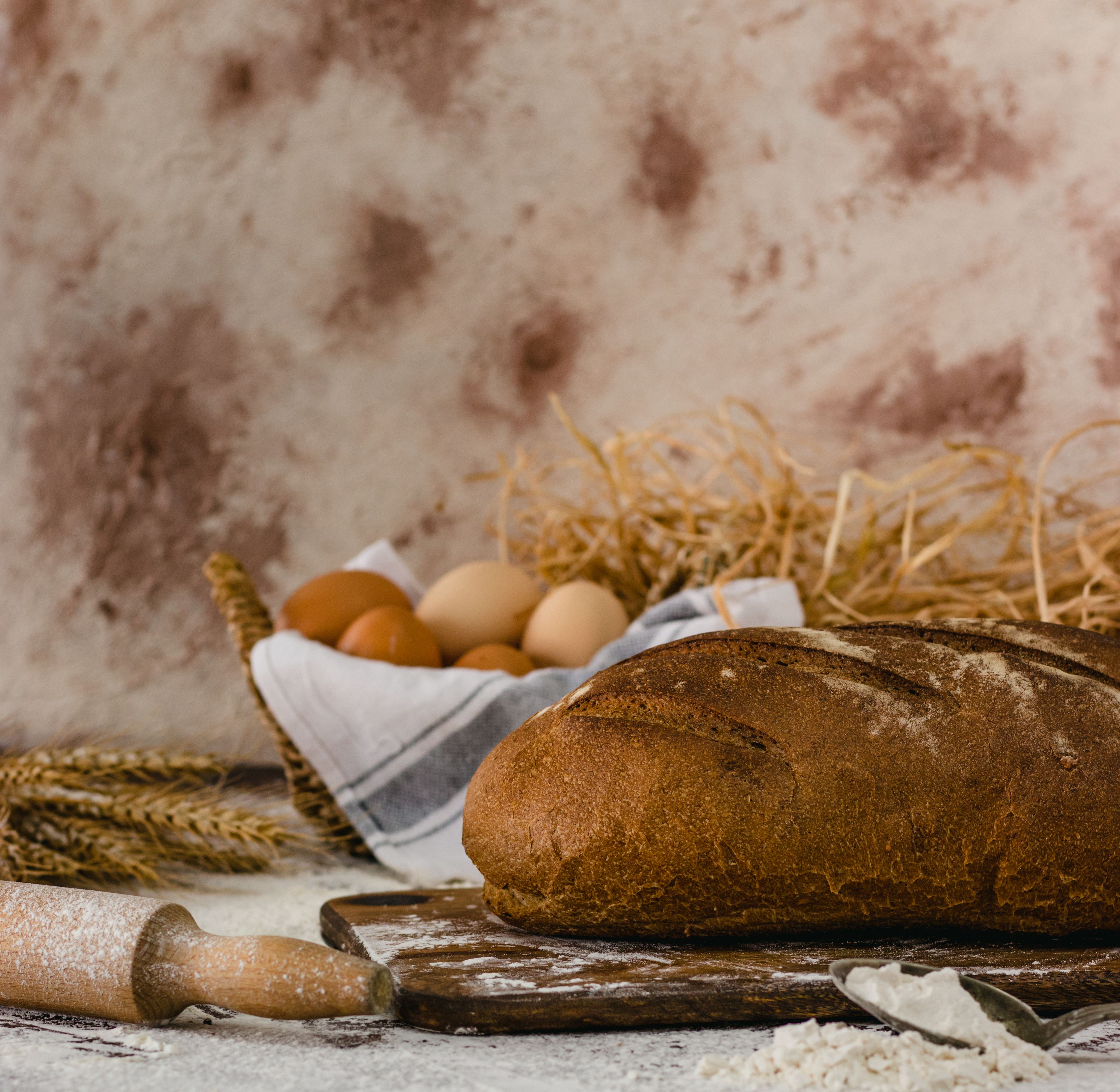 Artisanal Bread on Rustic Wooden Board · Free Stock Photo