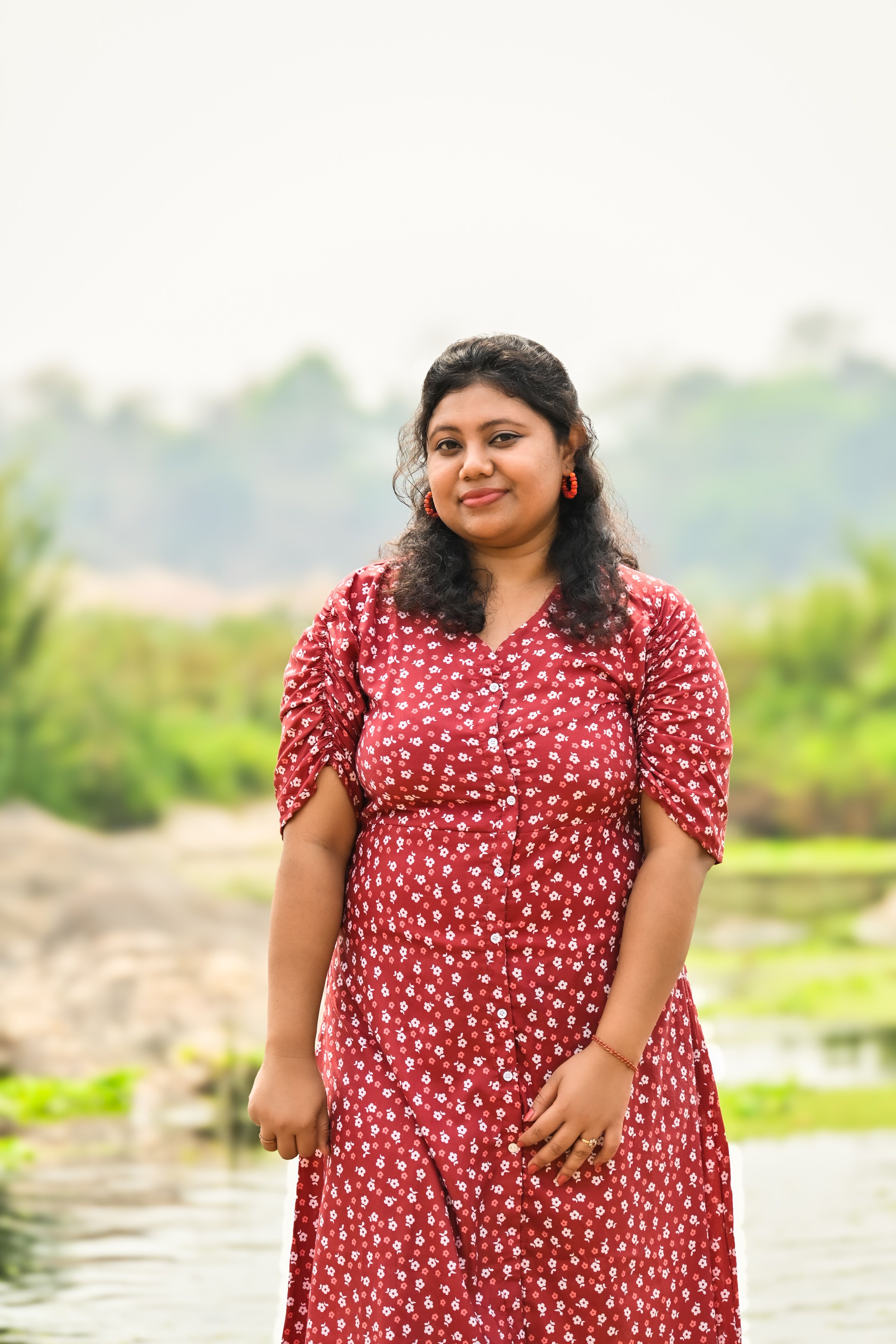 Woman in Red Floral Dress Poses Outdoors · Free Stock Photo
