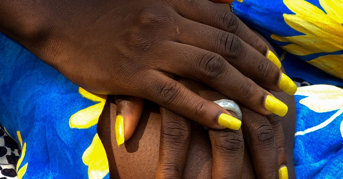 Color Yellow Hand Close-up of hands with yellow nail polish on vibrant fabric · Free ...