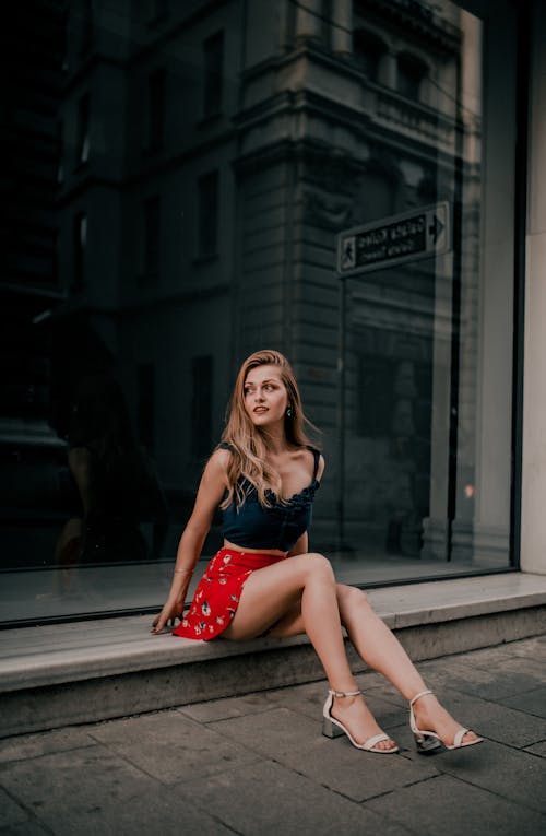 Free Woman in a black top and red skirt floral  sitting  Stock Photo