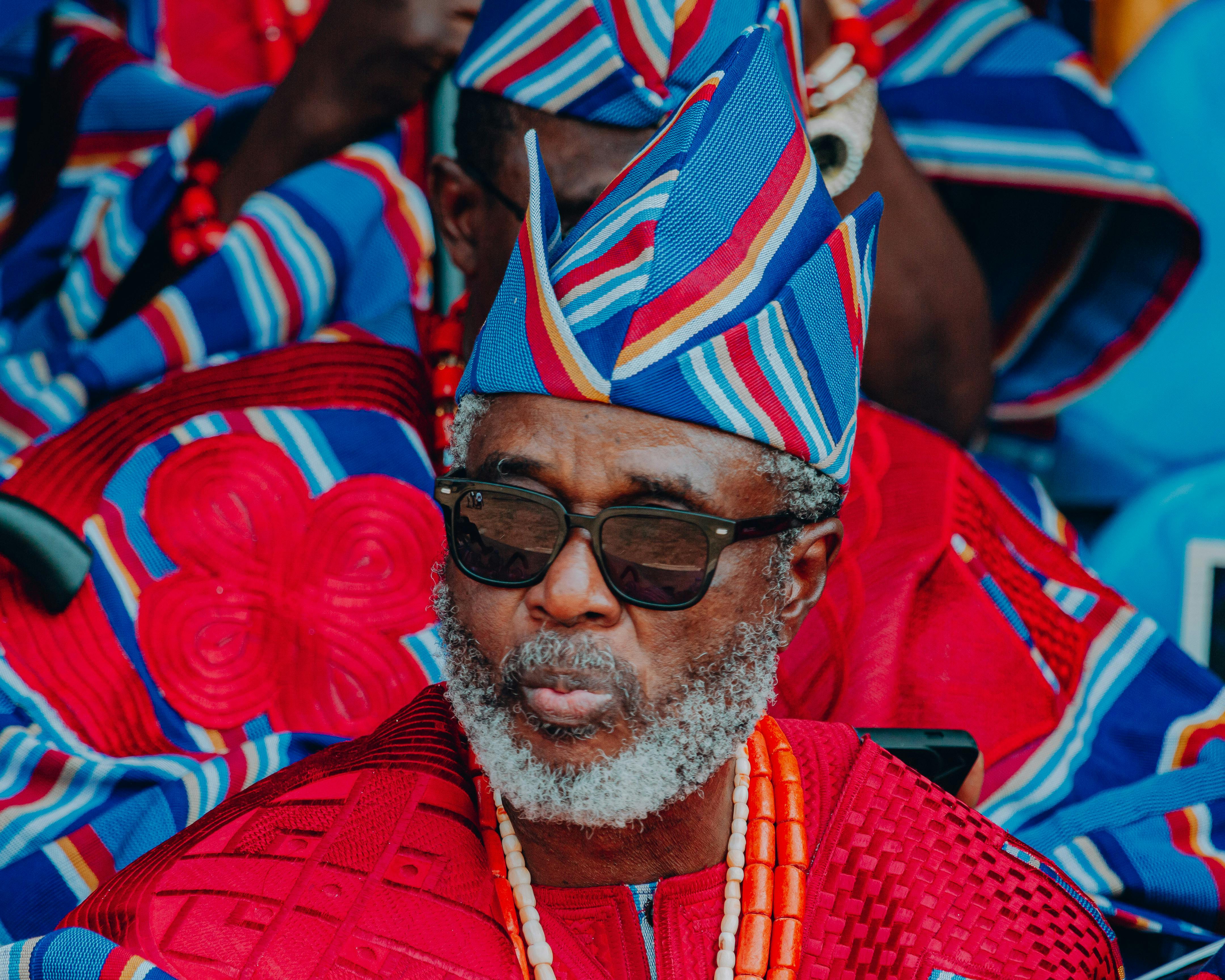 A striking portrait highlighting traditional Nigerian attire with vivid colors and cultural significance.