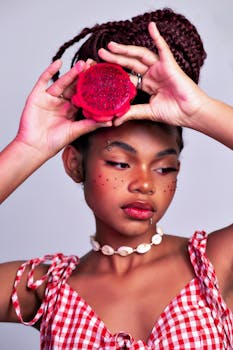 Vibrant portrait of a young woman holding a cut dragon fruit in Belo Horizonte, Brazil.
