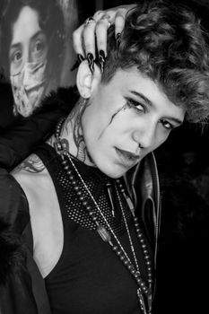 Dramatic black and white portrait highlighting edgy fashion and expressive emotion.
