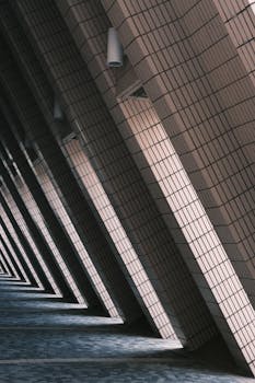 Artistic capture of a shadowed architectural hallway with geometric patterns and light contrasts.