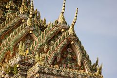 Close-up of ornate roof architecture at Wat Pho, showcasing traditional Thai design and craftsmanship.