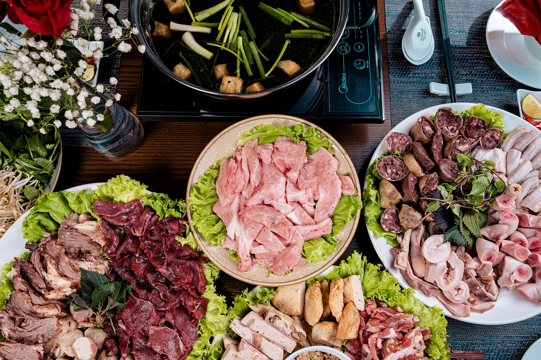 A variety of fresh meat and vegetables for making a traditional Asian hotpot meal.