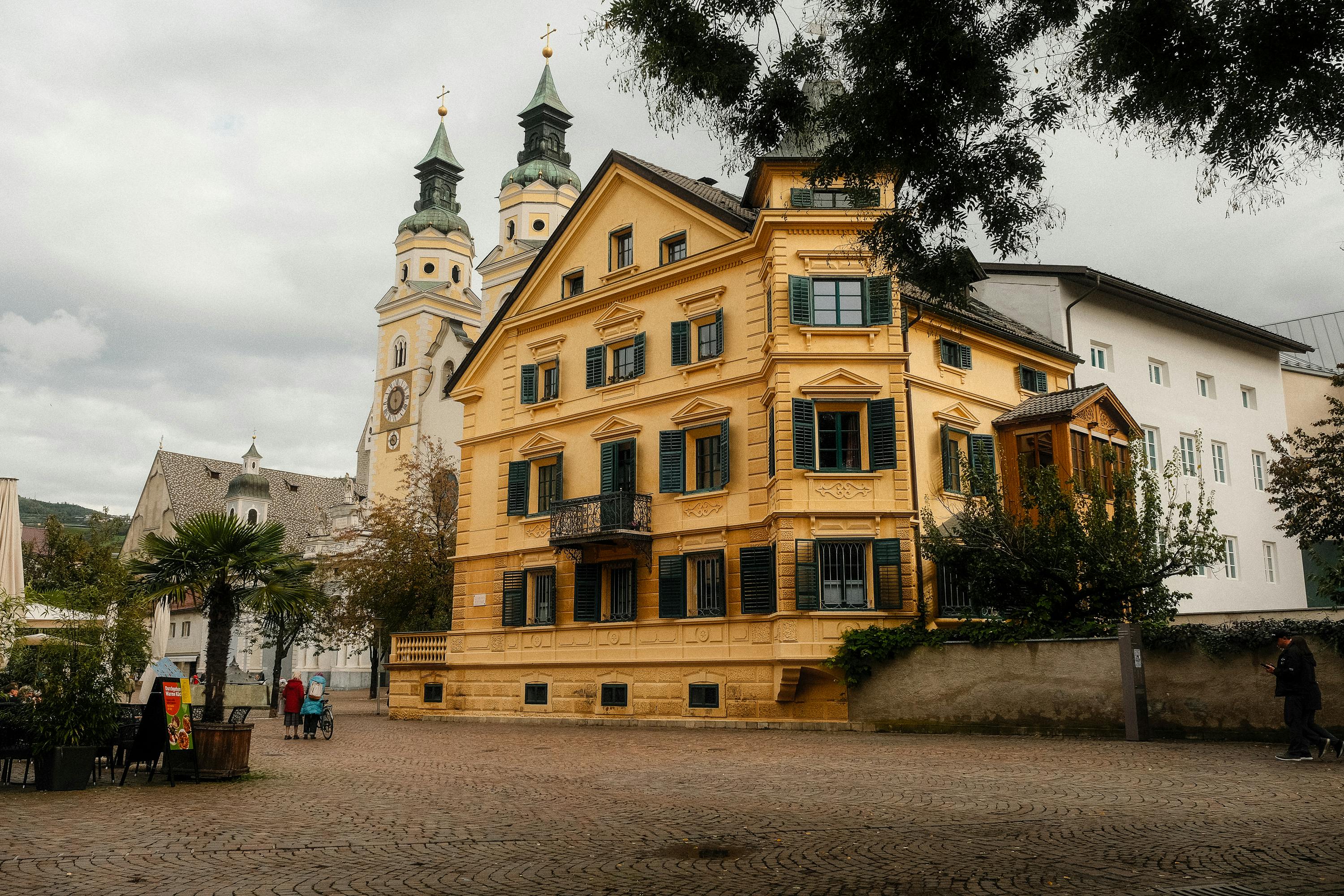 Quaint European square with classic architecture and church in a serene setting.