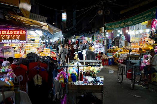 Vibrant night market scene with diverse stalls and people shopping under bright lights.