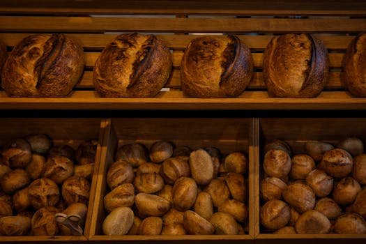 Rich selection of freshly baked artisan bread in a Berlin bakery shop.