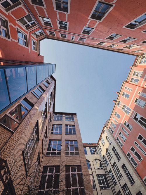 Free Stunning upward view of architectural buildings forming a courtyard in Berlin. Stock Photo