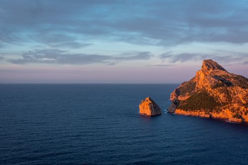 Free Stunning sunset view of Dragonera Island's rocky coast in the Balearic Islands. Stock Photo