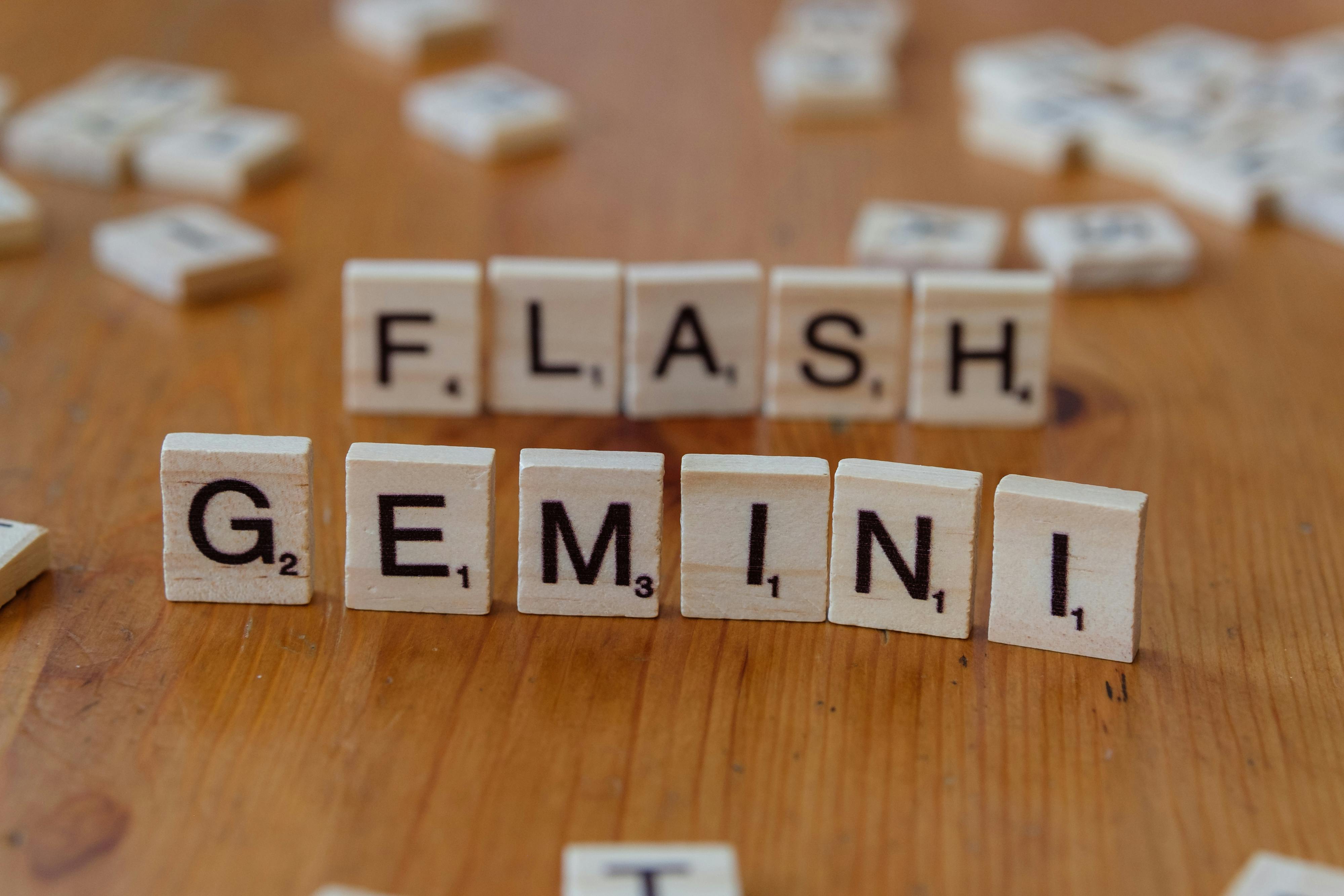 Wooden Scrabble tiles spelling 'Gemini' arranged on a wooden table.