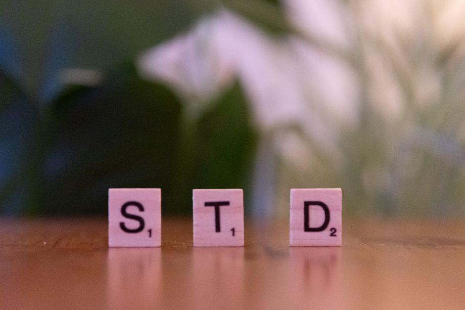 Scrabble tiles spelling 'STD' symbolize sexually transmitted diseases awareness and prevention.