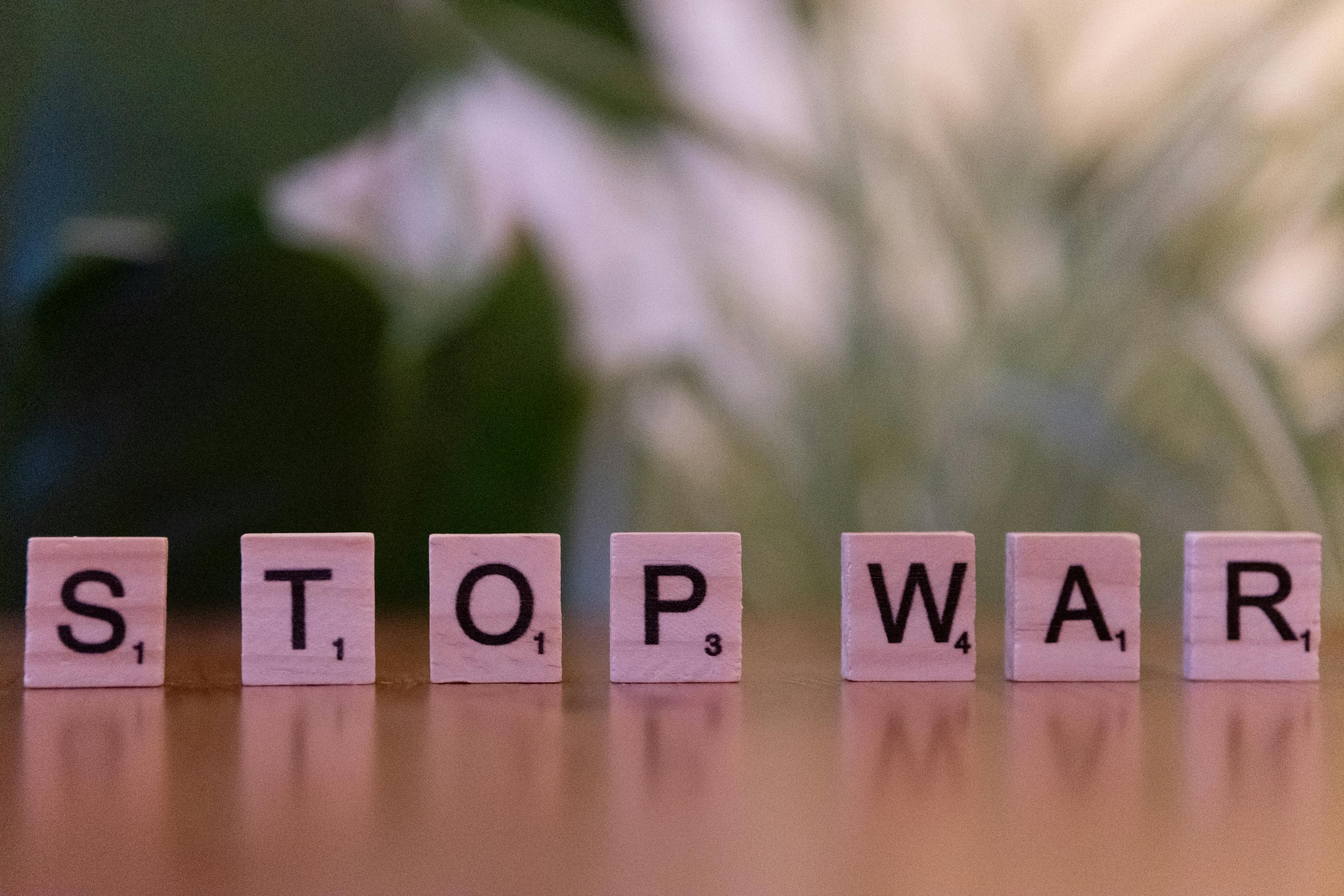 Wooden letter tiles spelling 'Stop War' symbolizing peace and anti-war activism.