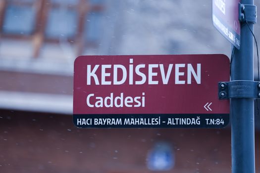 A detailed street sign in Kedi Seven Caddesi, Haci Bayram Mahallesi, Ankara, Türkiye captured during daytime.