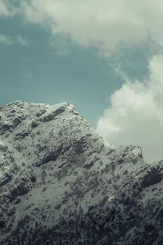 Majestic snow-covered mountains in Akre, Iraq, under a clear sky.