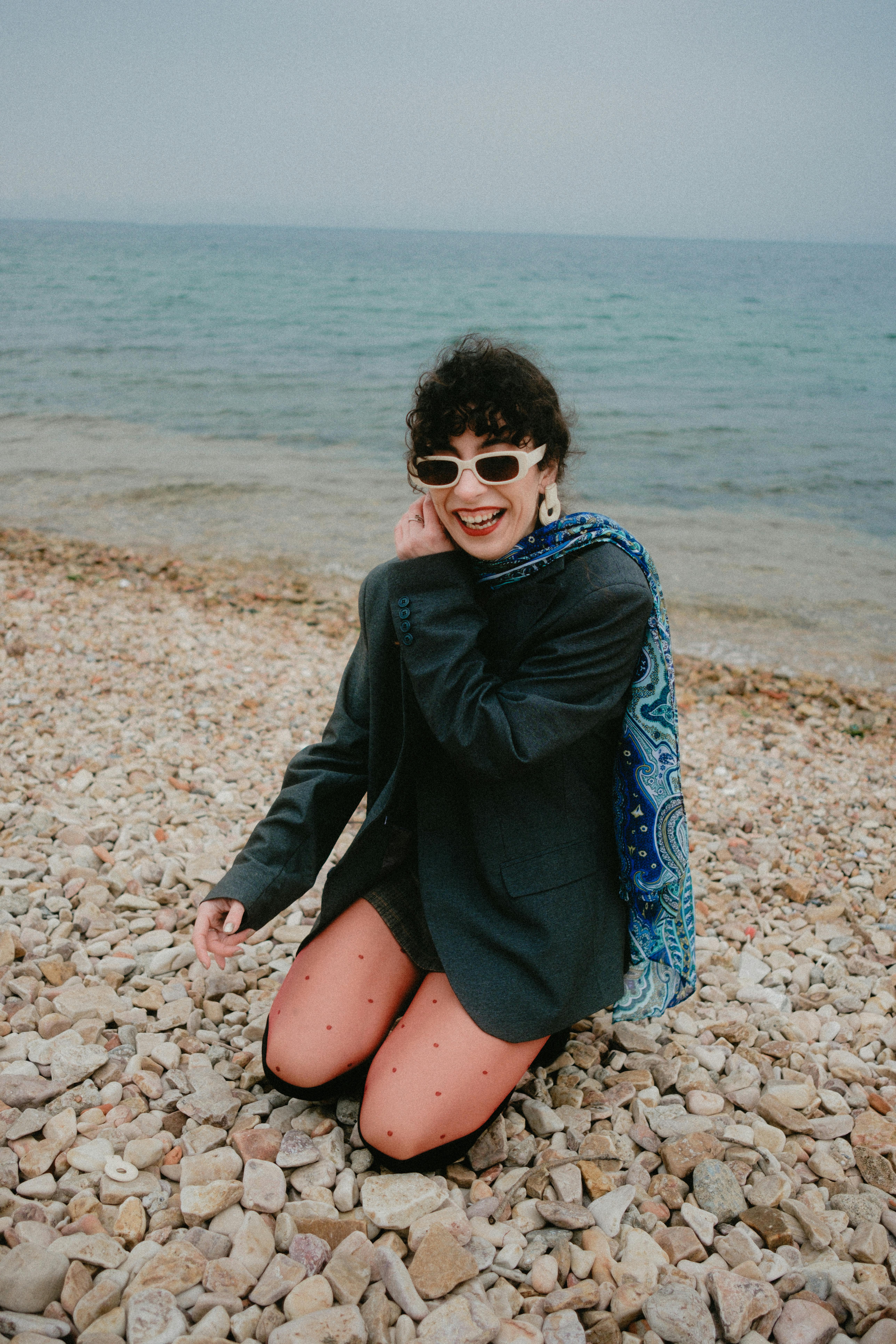 trendy woman enjoying a rocky beach day