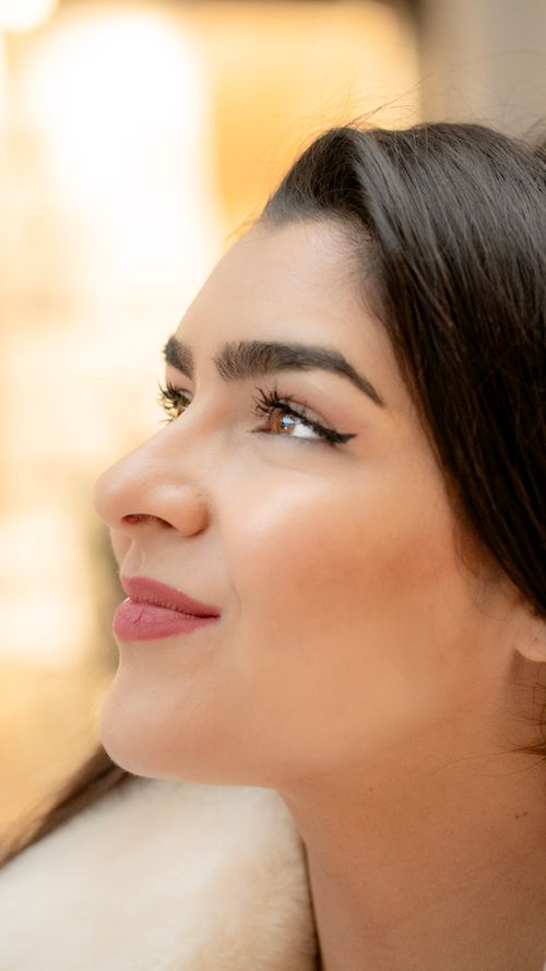 Free Side profile portrait of a smiling woman with winter fashion in Milan, Italy. Stock Photo