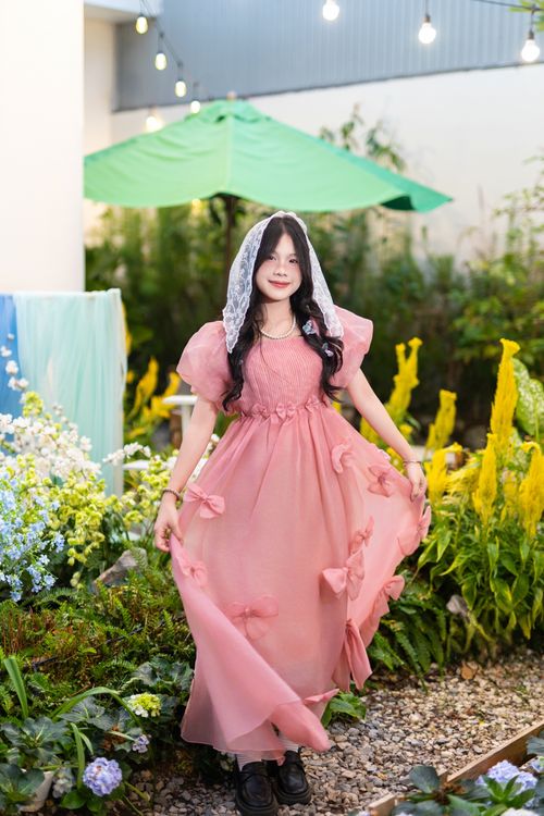 Young girl in pink dress in garden setting · Free Stock Photo