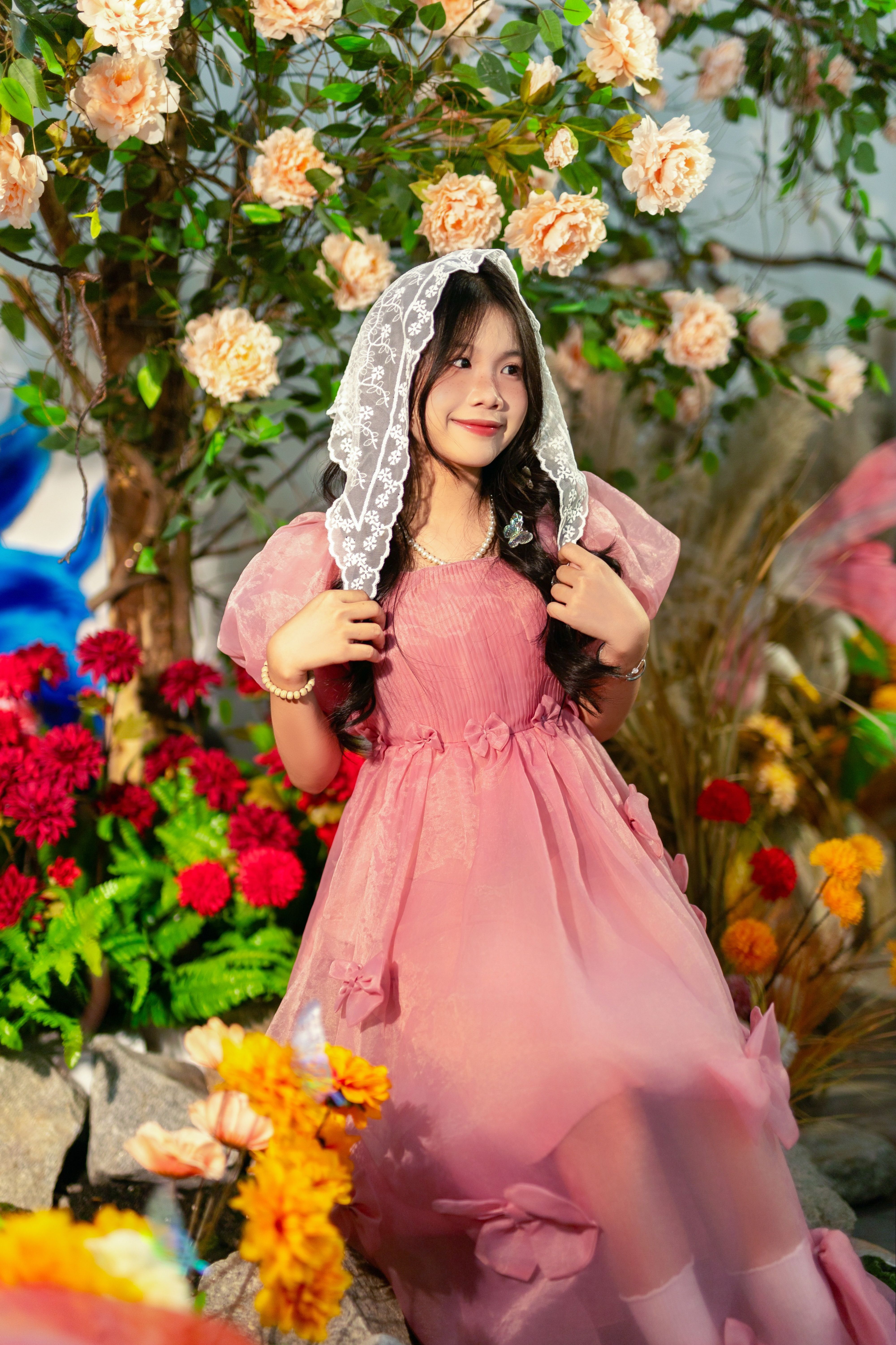 Young Girl in Pink Dress Amidst Garden Blooms · Free Stock Photo