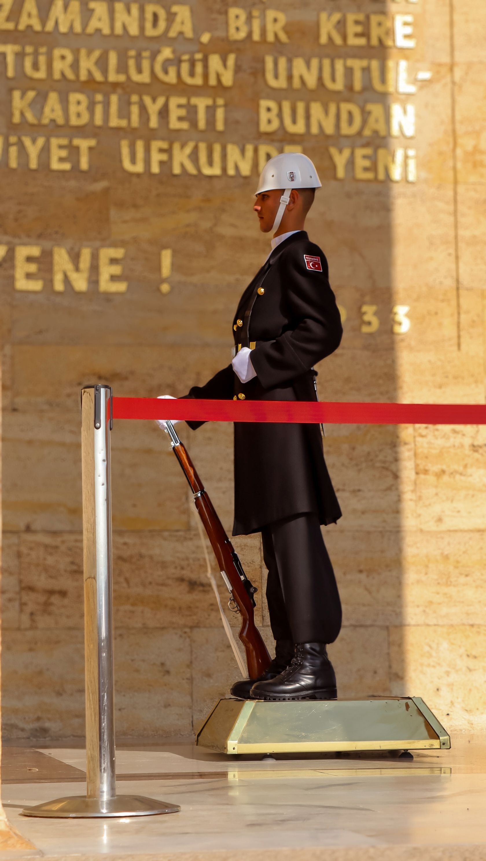 A Turkish ceremonial guard stands vigil at Anıtkabir, displaying national pride.