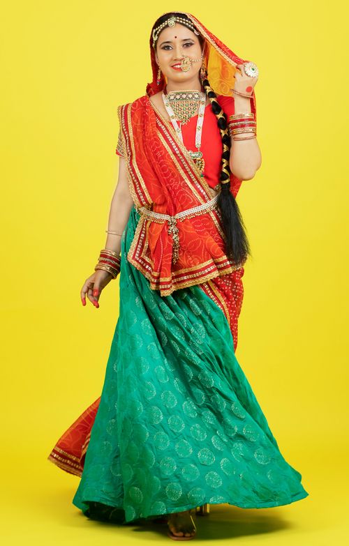 Free Portrait of an Indian woman wearing vibrant Rajasthani traditional clothing with jewelry. Stock Photo