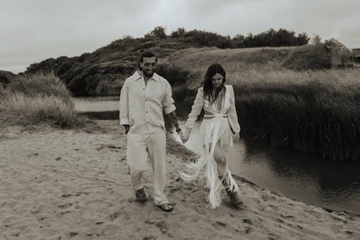 Couple walking hand in hand by a river, embracing love and tranquility in a lush, serene setting.