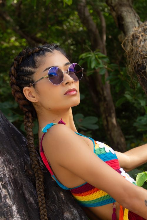 Free Young woman in vibrant attire, relaxing outdoors in the lush Brazilian jungle. Stock Photo