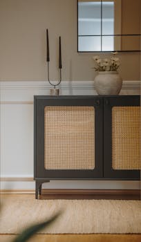 Stylish interior featuring a cane panel cabinet, decorative vase, and minimalistic decor.