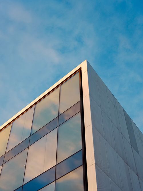 Free A modern glass building reflecting the sky in Oslo, Norway. Stock Photo